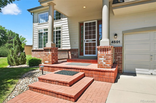 4501 Whitehall Ln, Highlands Ranch, CO 80126 - entrance to property featuring covered porch, brick siding, and driveway