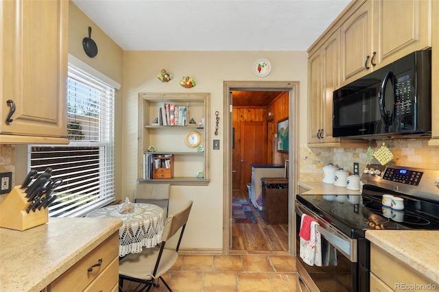 1317 E Uintah St, Colorado Springs, CO 80909 - kitchen with black microwave, stainless steel range with electric cooktop, light countertops, and backsplash