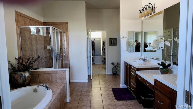 full bathroom with a stall shower, vanity, a bath, and tile patterned floors