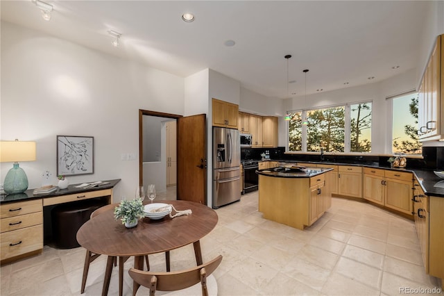 kitchen with pendant lighting, backsplash, sink, a kitchen island, and stainless steel appliances