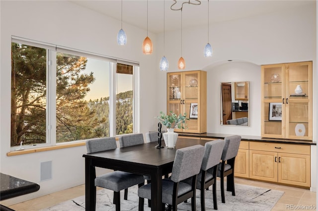 tiled dining room featuring a high ceiling