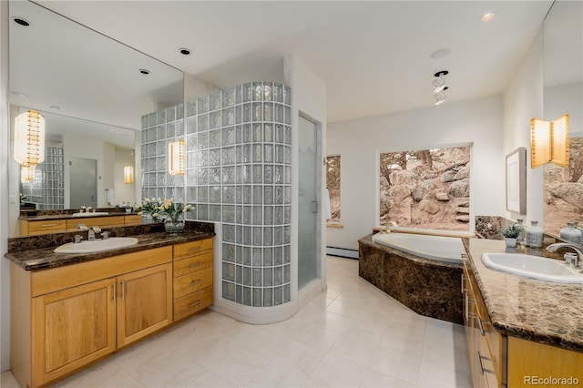 bathroom with tile patterned flooring, vanity, shower with separate bathtub, and a baseboard heating unit