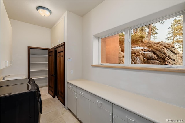 interior space featuring gray cabinetry and washer and dryer