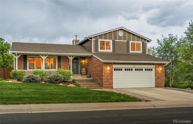 split level home with a garage, driveway, brick siding, and a front lawn