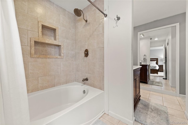 ensuite bathroom featuring shower / bathtub combination with curtain, connected bathroom, vanity, tile patterned flooring, and baseboards