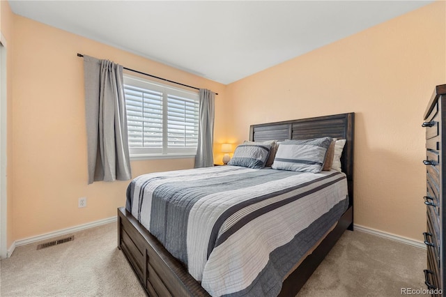 carpeted bedroom with visible vents and baseboards