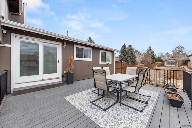 wooden deck with outdoor dining space and fence