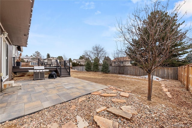 view of yard with a fenced backyard, a patio, and a deck