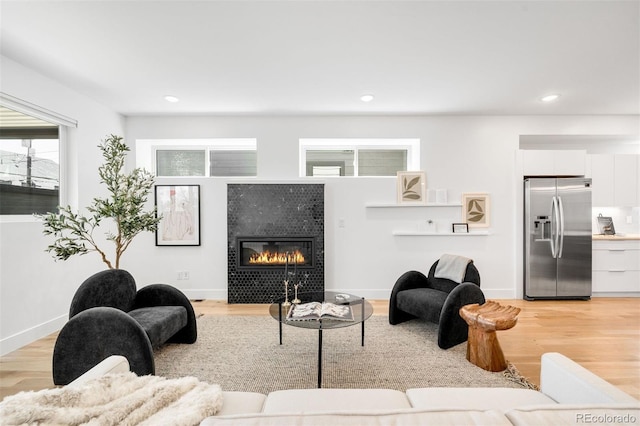 3658 Quivas St, Denver, CO 80211 - living area featuring a tile fireplace, light wood-style floors, recessed lighting, and baseboards