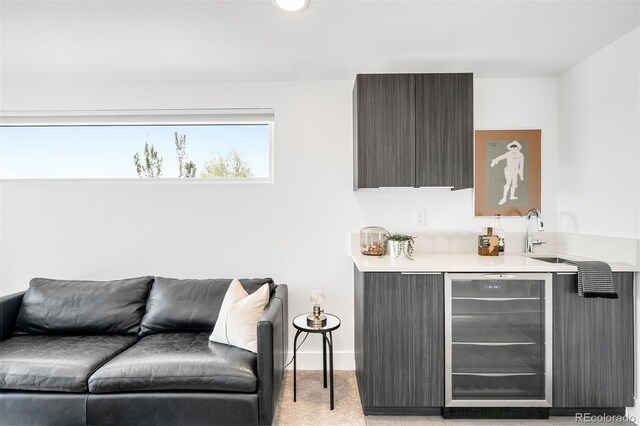 3658 Quivas St, Denver, CO 80211 - living room with beverage cooler, bar with sink, light carpet, baseboards, and recessed lighting