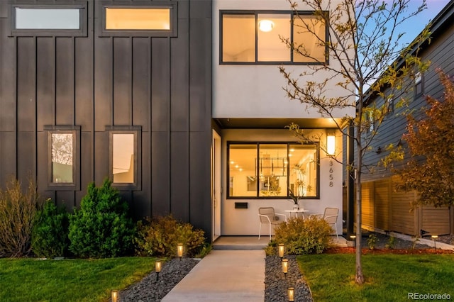 3658 Quivas St, Denver, CO 80211 - view of exterior entry with board and batten siding and a lawn