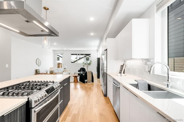 3658 Quivas St, Denver, CO 80211 - kitchen with stainless steel appliances, exhaust hood, light countertops, and recessed lighting