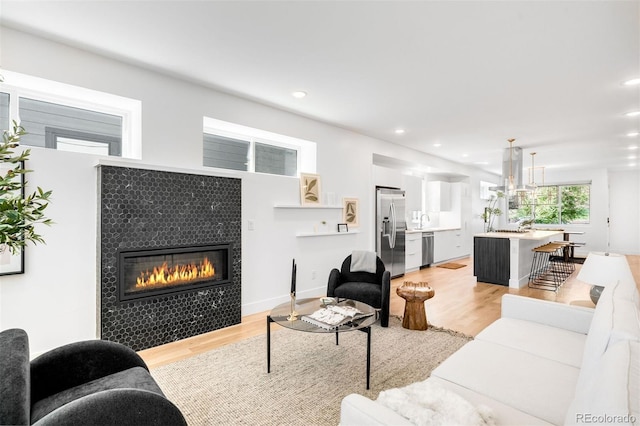 3658 Quivas St, Denver, CO 80211 - living room with a tiled fireplace, light wood-style floors, and recessed lighting