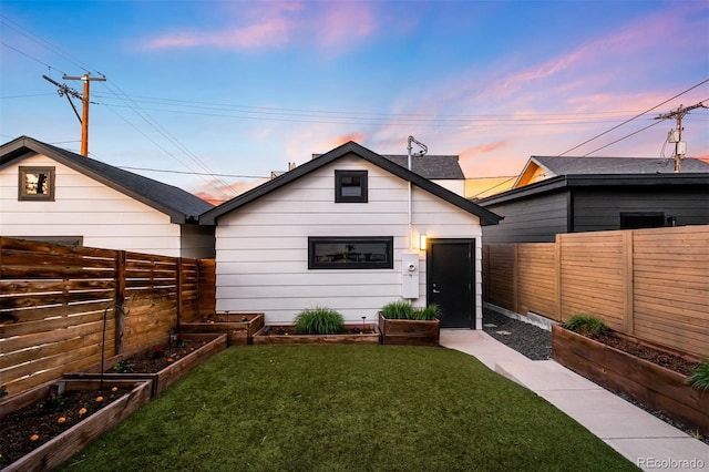 3658 Quivas St, Denver, CO 80211 - back of house at dusk with a vegetable garden