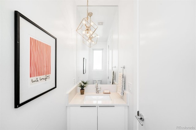 3658 Quivas St, Denver, CO 80211 - bathroom with a chandelier, vanity, and toilet