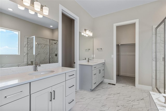 bathroom with vanity and a shower with door