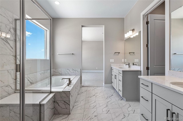 bathroom featuring vanity and separate shower and tub