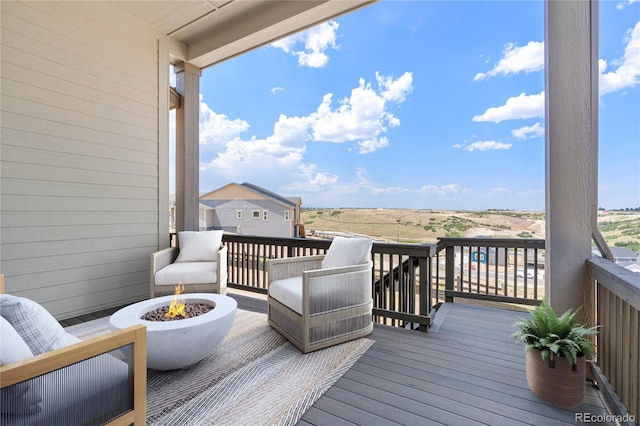 wooden terrace with a fire pit