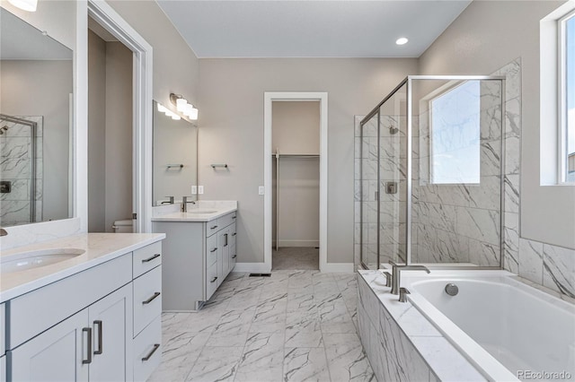 full bathroom featuring vanity, toilet, and separate shower and tub