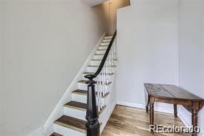 stairway with hardwood / wood-style flooring