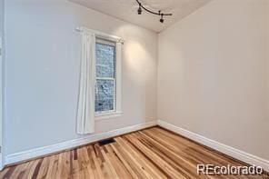 unfurnished room with hardwood / wood-style floors