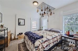 bedroom featuring carpet floors and a notable chandelier