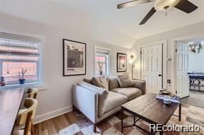 living room featuring lofted ceiling, ceiling fan, and hardwood / wood-style flooring