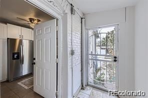 interior space with ceiling fan and a barn door