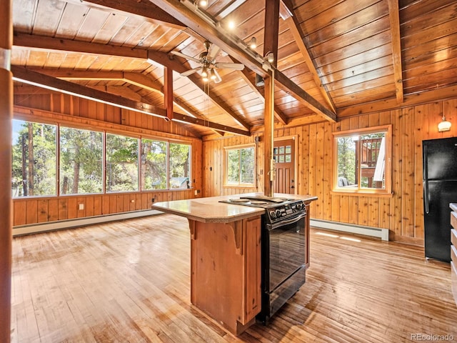 48 Warren Rd, Black Hawk, CO 80422 - kitchen featuring a baseboard radiator, light wood-style flooring, black appliances, and vaulted ceiling with beams