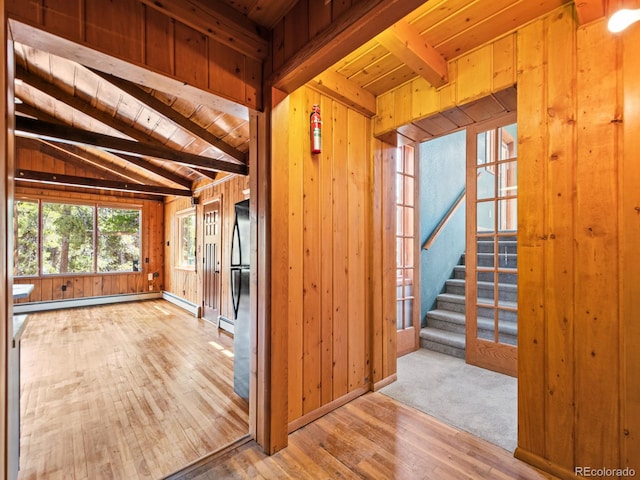 48 Warren Rd, Black Hawk, CO 80422 - interior space with lofted ceiling with beams, hardwood / wood-style floors, a baseboard heating unit, wooden ceiling, and wooden walls