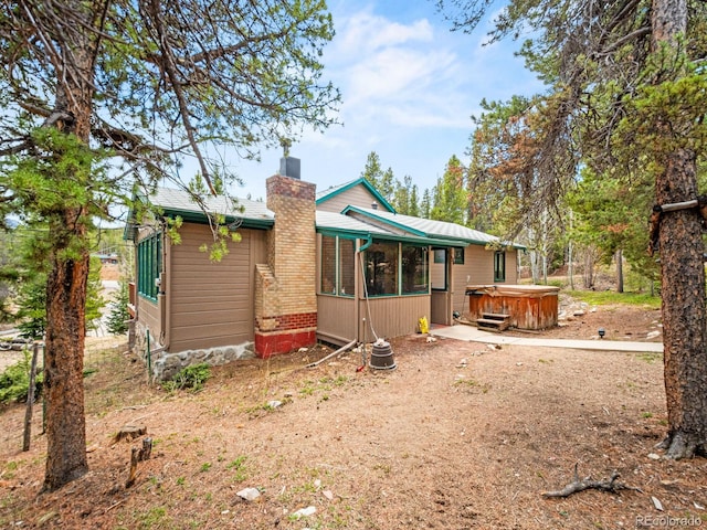 48 Warren Rd, Black Hawk, CO 80422 - rear view of house with a chimney and a hot tub