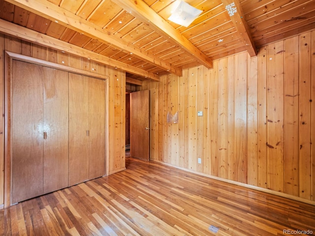 48 Warren Rd, Black Hawk, CO 80422 - unfurnished bedroom with wood walls, a closet, wooden ceiling, wood-type flooring, and beamed ceiling