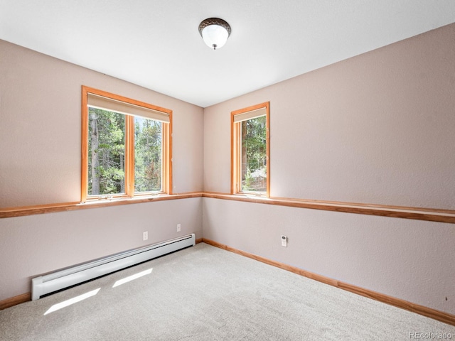 48 Warren Rd, Black Hawk, CO 80422 - empty room with a baseboard heating unit, baseboards, a healthy amount of sunlight, and carpet