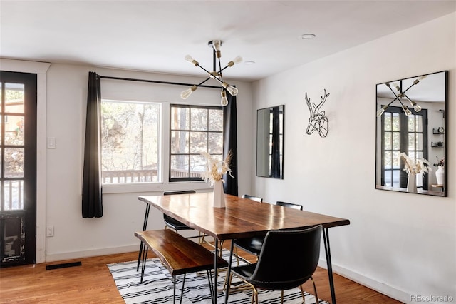 dining room featuring a chandelier and hardwood / wood-style flooring