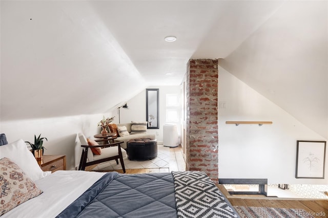 bedroom featuring light hardwood / wood-style floors and vaulted ceiling