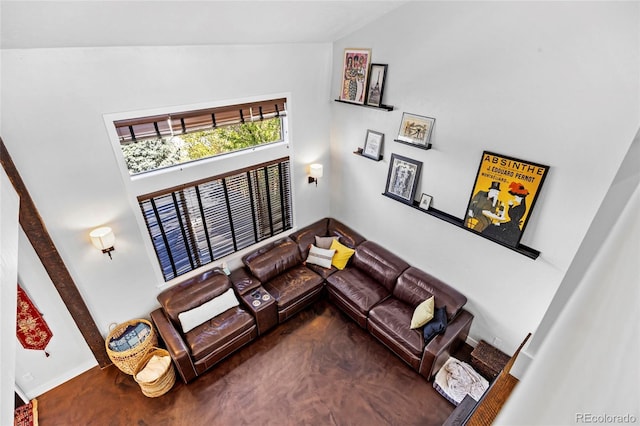 living area featuring concrete floors and lofted ceiling