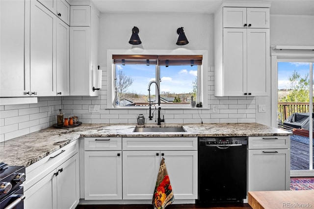 kitchen featuring backsplash, white cabinets, a sink, and black appliances