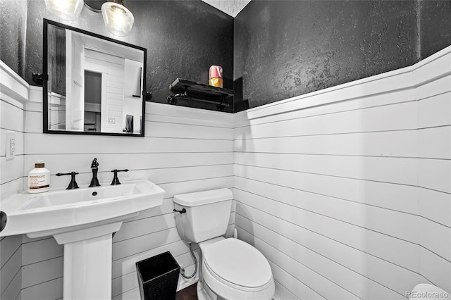 half bath with a sink and toilet