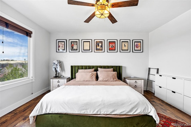 bedroom featuring baseboards, a ceiling fan, and dark wood-style floors