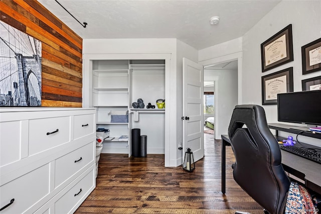office with dark wood-type flooring and wood walls