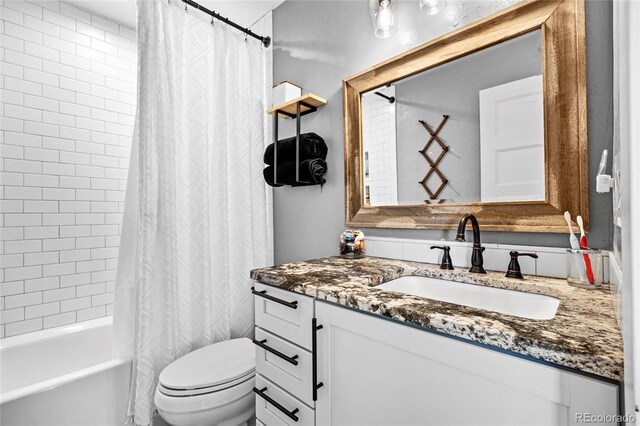 bathroom featuring vanity, shower / bath combination with curtain, and toilet
