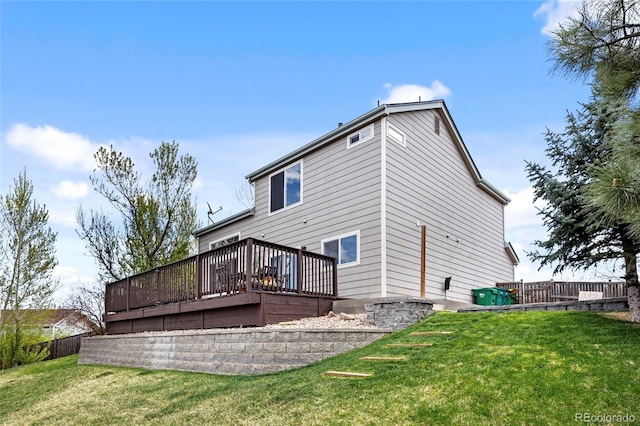 back of property with a lawn and a wooden deck