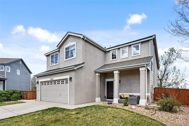 traditional-style home featuring a front yard, a garage, fence, concrete driveway, and stucco siding