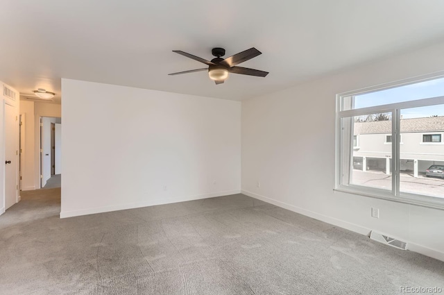 spare room featuring carpet floors and ceiling fan