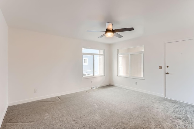 carpeted spare room with ceiling fan