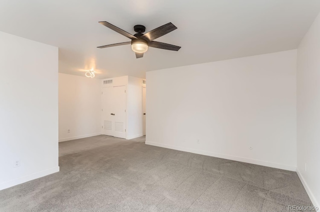 spare room featuring light colored carpet and ceiling fan