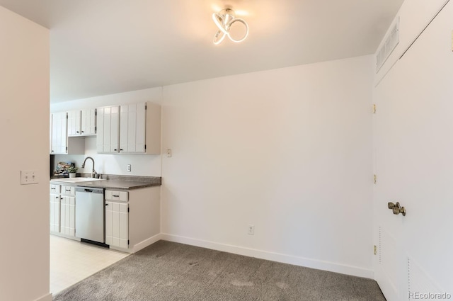 kitchen featuring light carpet, sink, white cabinets, and dishwasher