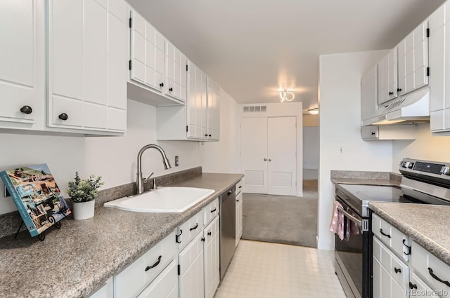 kitchen with stainless steel appliances, sink, and white cabinets