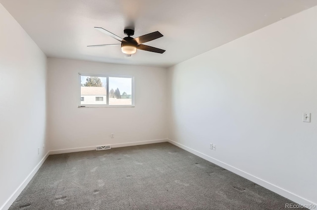 carpeted spare room featuring ceiling fan