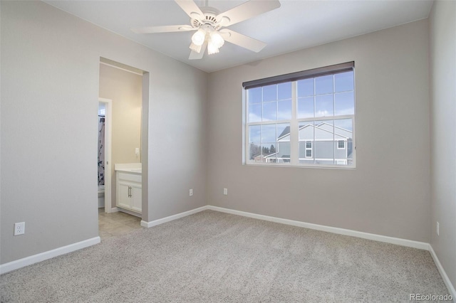 carpeted spare room featuring ceiling fan